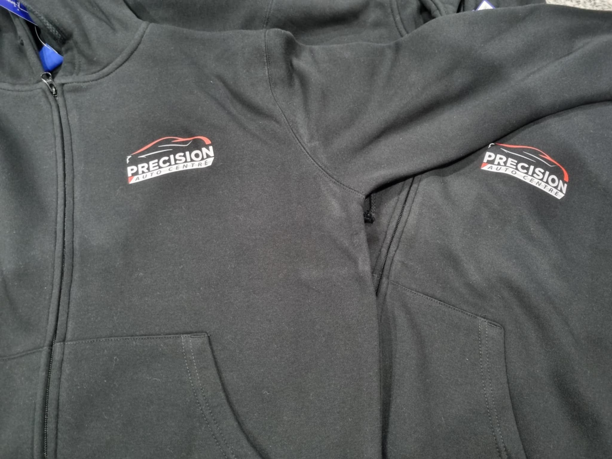 Gray jacket with 'Precision' logo on a gray background