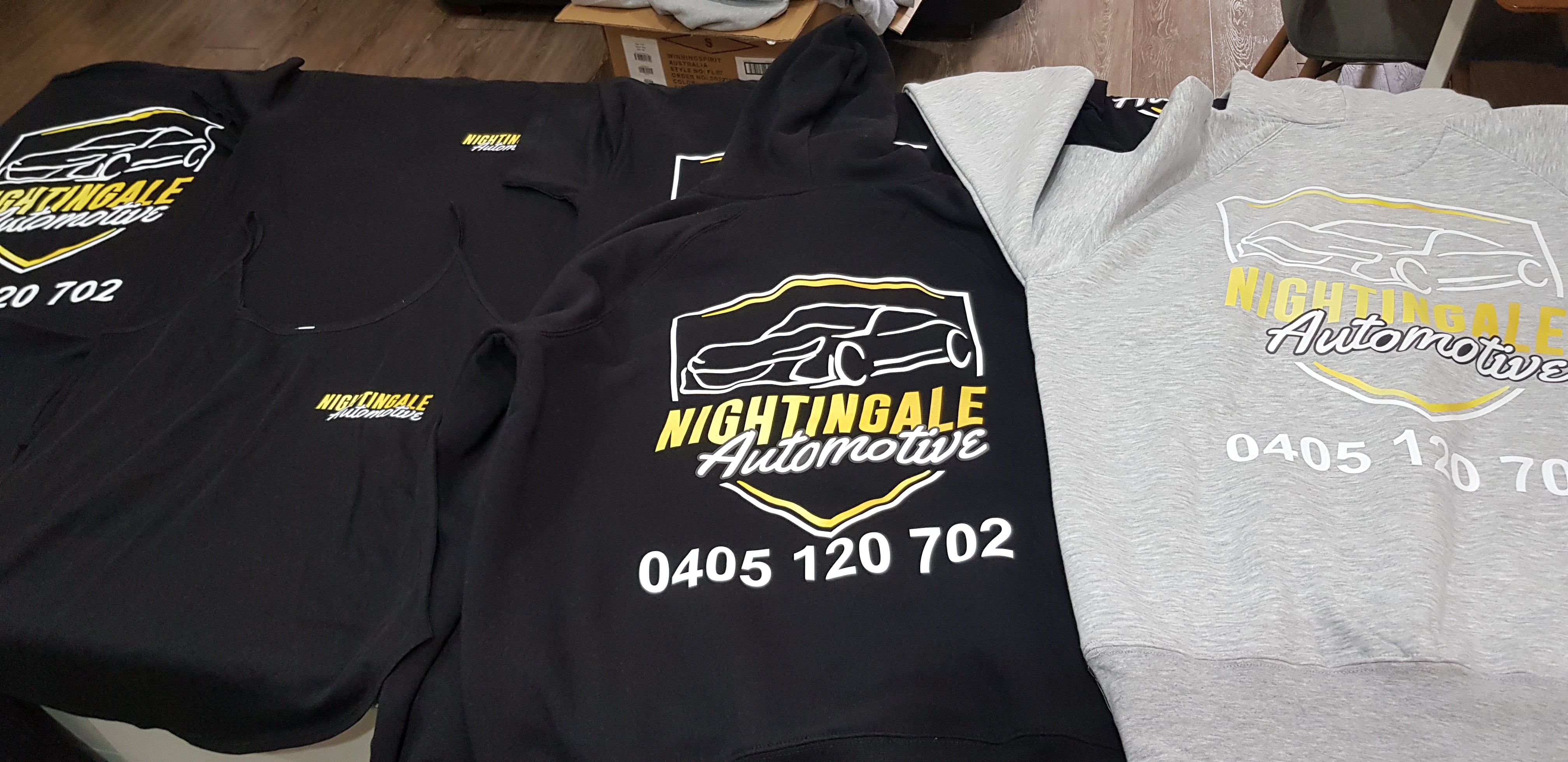Black and gray hoodies with Nightingale Automotive logo and contact information.